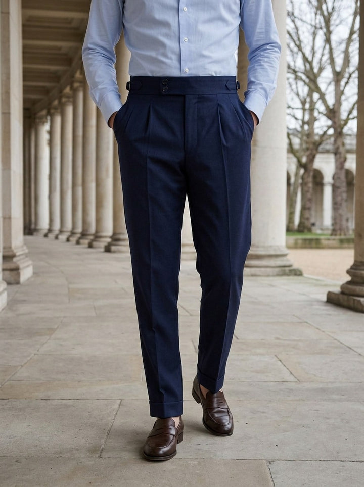 Paxton pleated trousers in Navy, lifestyle in a stone colonnade, Gentlemens Manor