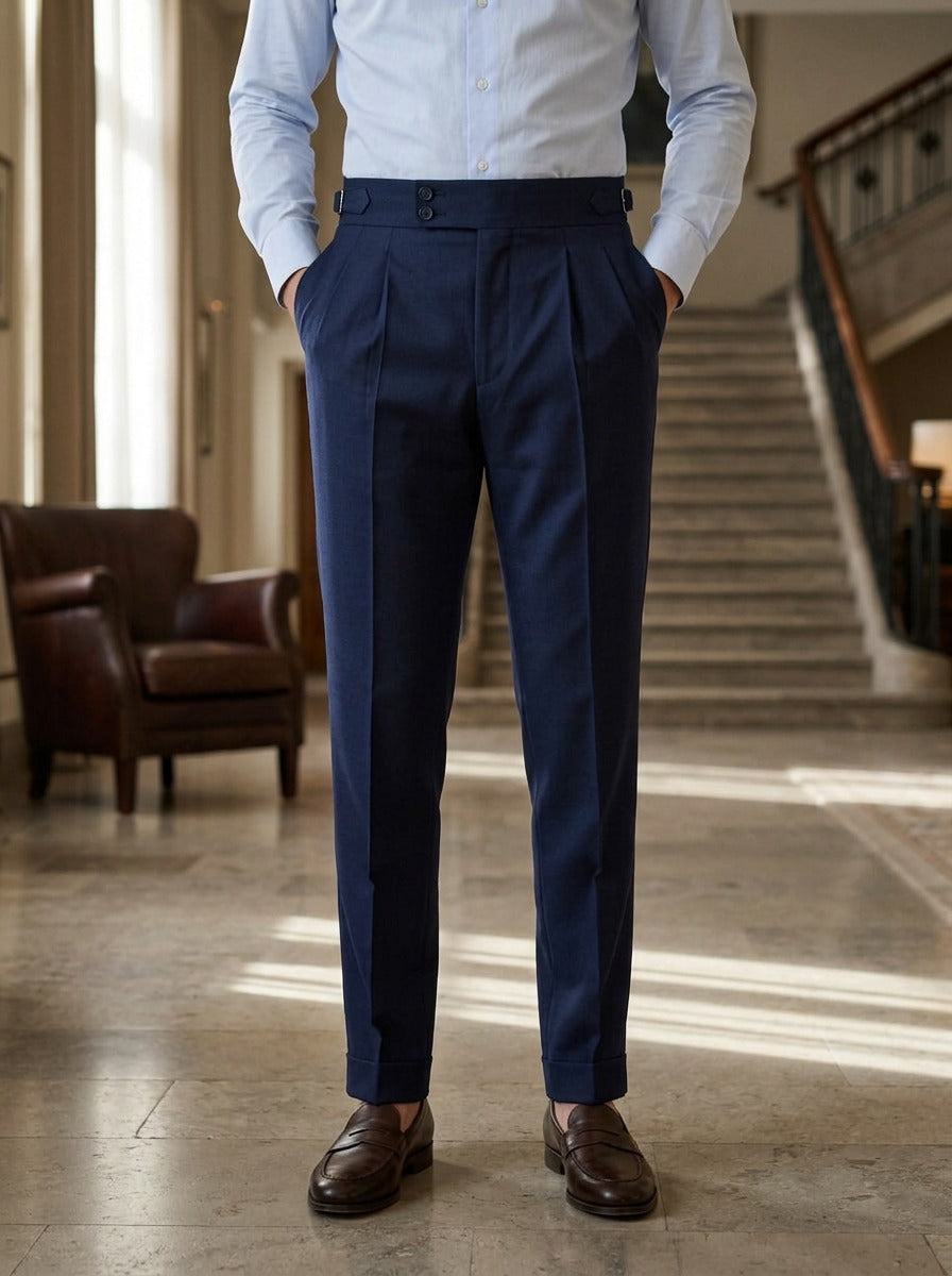 Paxton pleated trousers in Navy, lifestyle in a hotel lobby, Gentlemens Manor