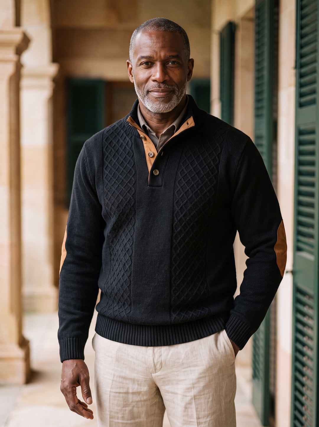 Pearce sweater in Black, worn by a model in a Mediterranean setting - Gentlemens Manor lifestyle
