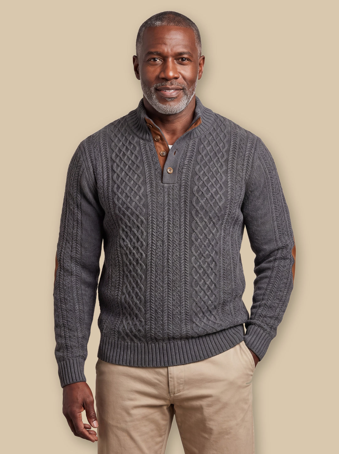 Pearce knit sweater in Charcoal, worn by a model on a warm sand studio background - Gentlemens Manor