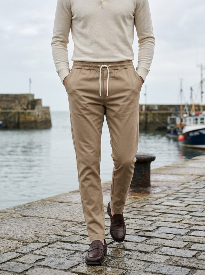 Pendleton slim twill drawstring trousers in Sand, lifestyle on a stone harbor quay, Gentlemens Manor