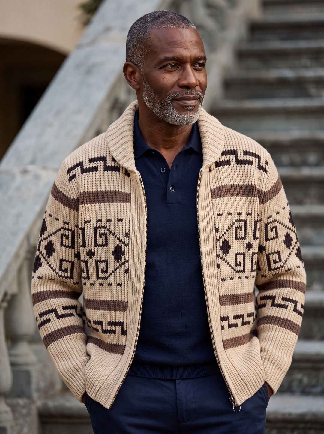 Percy cardigan in Sand, worn by a model in a Mediterranean setting - Gentlemens Manor lifestyle