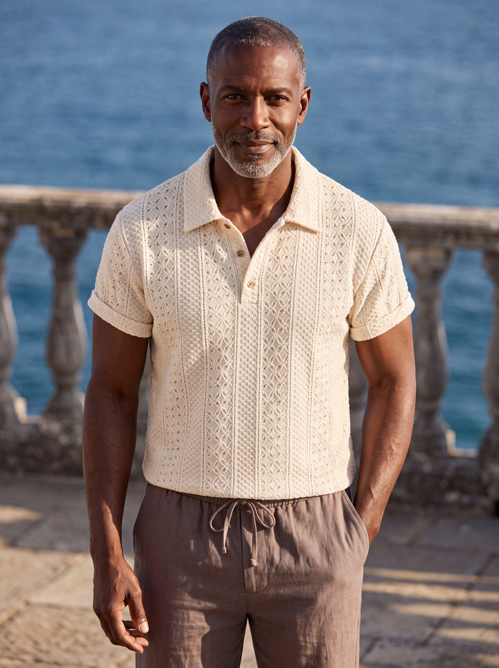 Peter Men polo shirt in cream, worn by a model on a Mediterranean terrace - Gentlemens Manor lifestyle