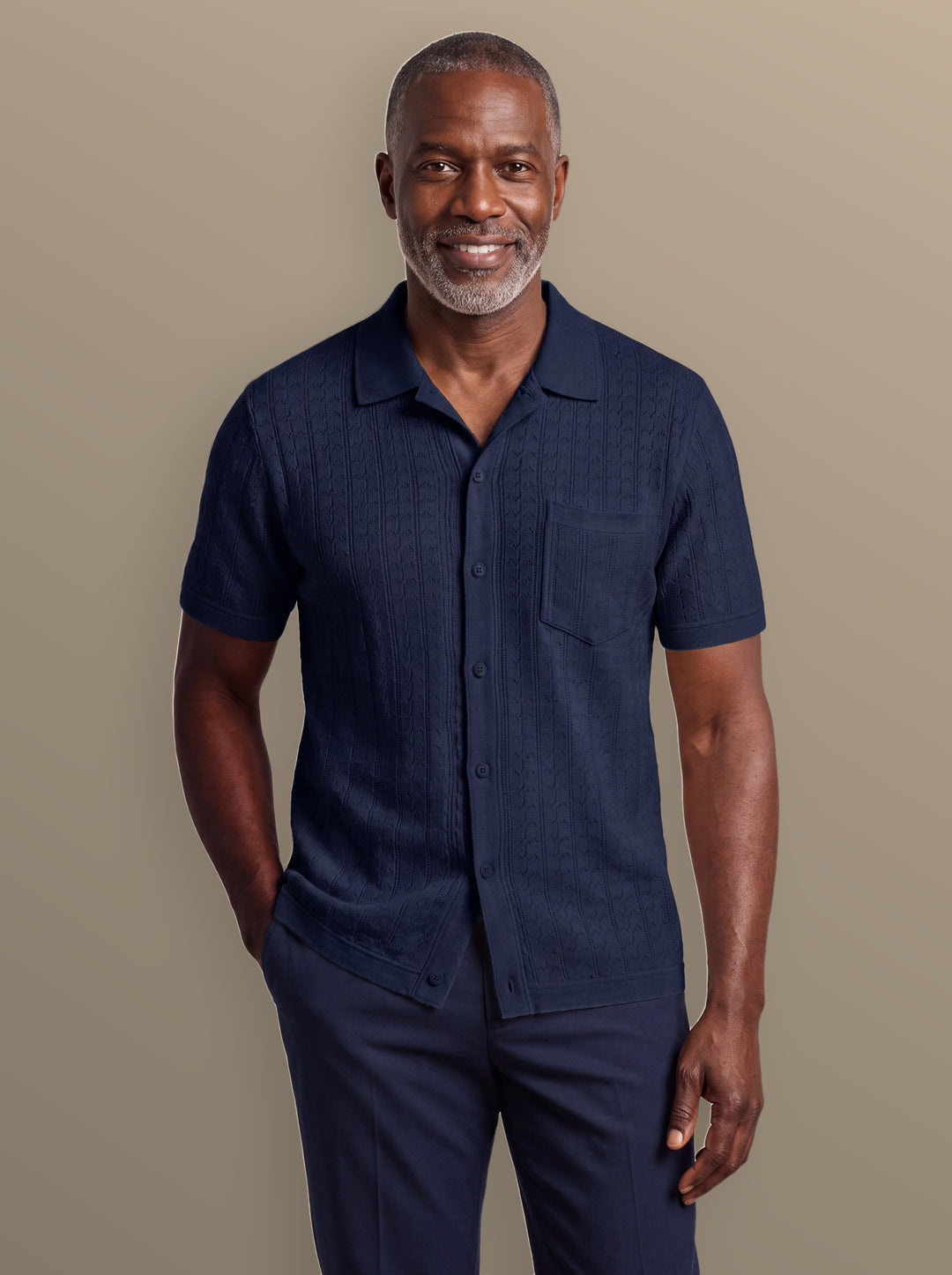 Peyton knit button-down shirt in Navy, worn by a model on a warm studio background - Gentlemens Manor
