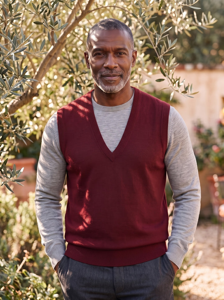 Phineas sweater vest in Burgundy, worn by a model in a Mediterranean setting - Gentlemens Manor lifestyle