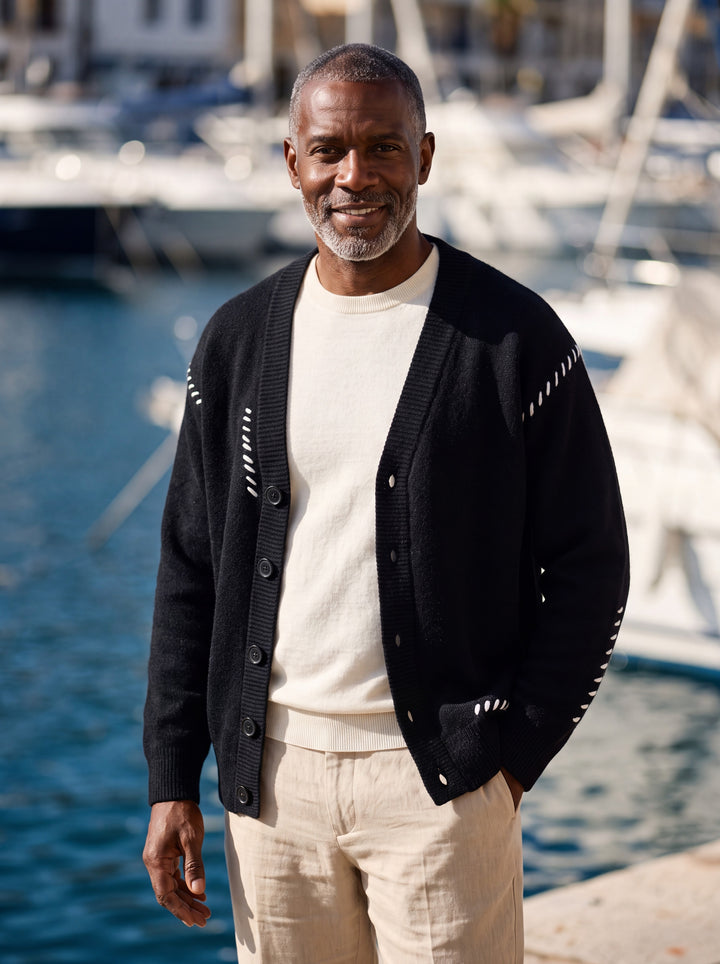 Pierce cardigan in Black, worn by a model in a Mediterranean setting - Gentlemens Manor lifestyle