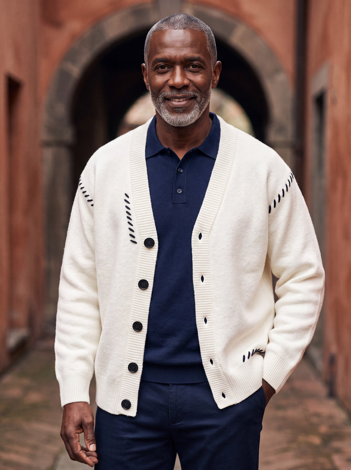 Pierce cardigan in White, worn by a model in a Mediterranean setting - Gentlemens Manor lifestyle