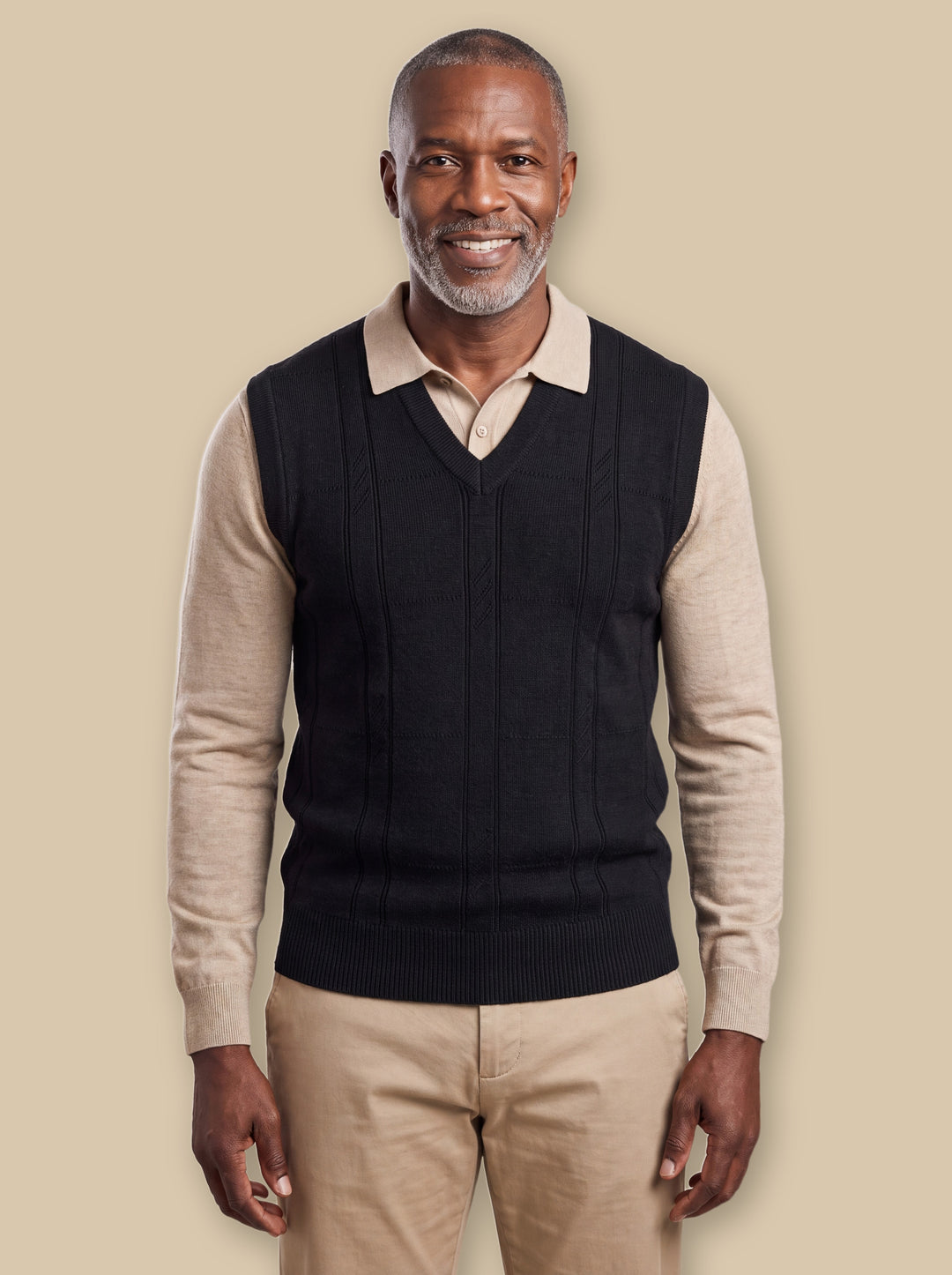 Porter knit sweater in Black, worn by a model on a warm sand studio background - Gentlemens Manor