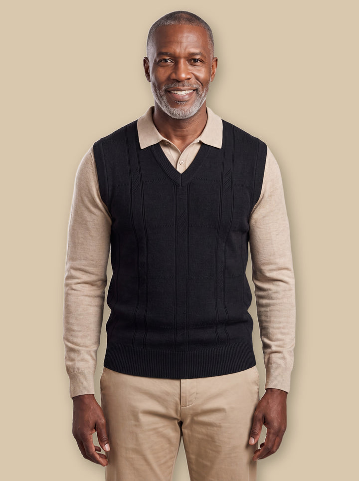Porter knit sweater in Black, worn by a model on a warm sand studio background - Gentlemens Manor