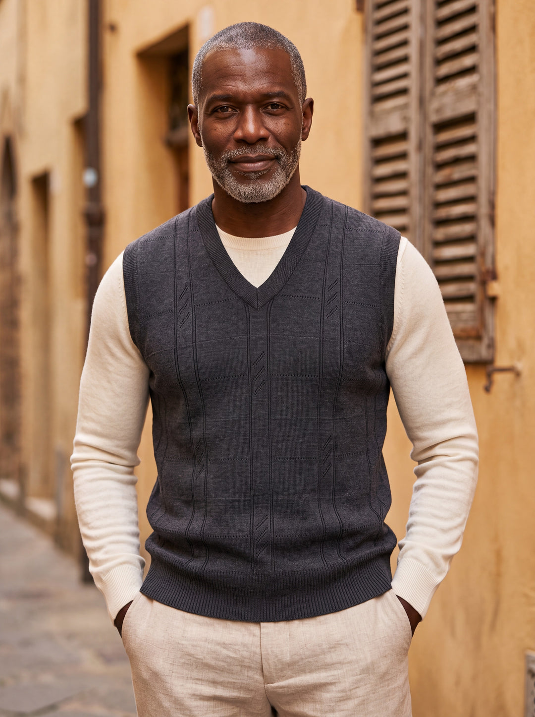 Porter vest in Charcoal, worn by a model in a Mediterranean setting - Gentlemens Manor lifestyle