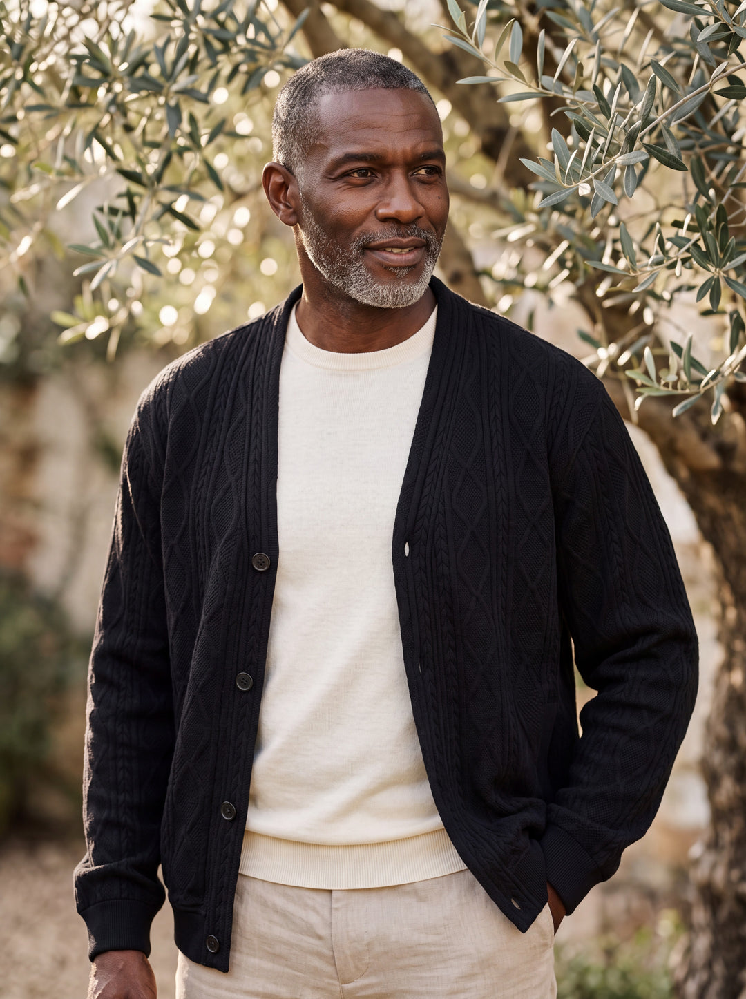 Prentice cardigan in Black, worn by a model in a Mediterranean setting - Gentlemens Manor lifestyle