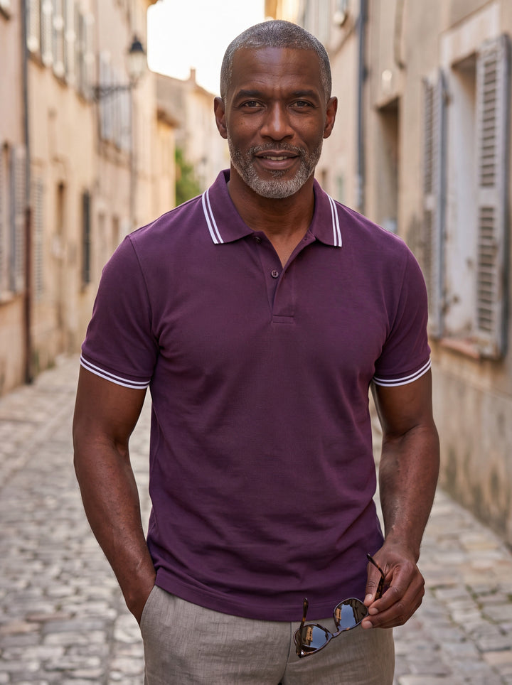 Preston Men polo shirt in purple, worn by a model on a Mediterranean terrace - Gentlemens Manor lifestyle