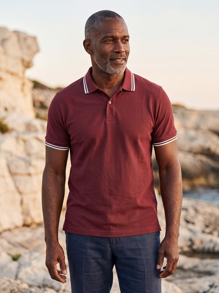 Preston Men polo shirt in Burgundy, worn by a model on a Mediterranean terrace - Gentlemens Manor lifestyle