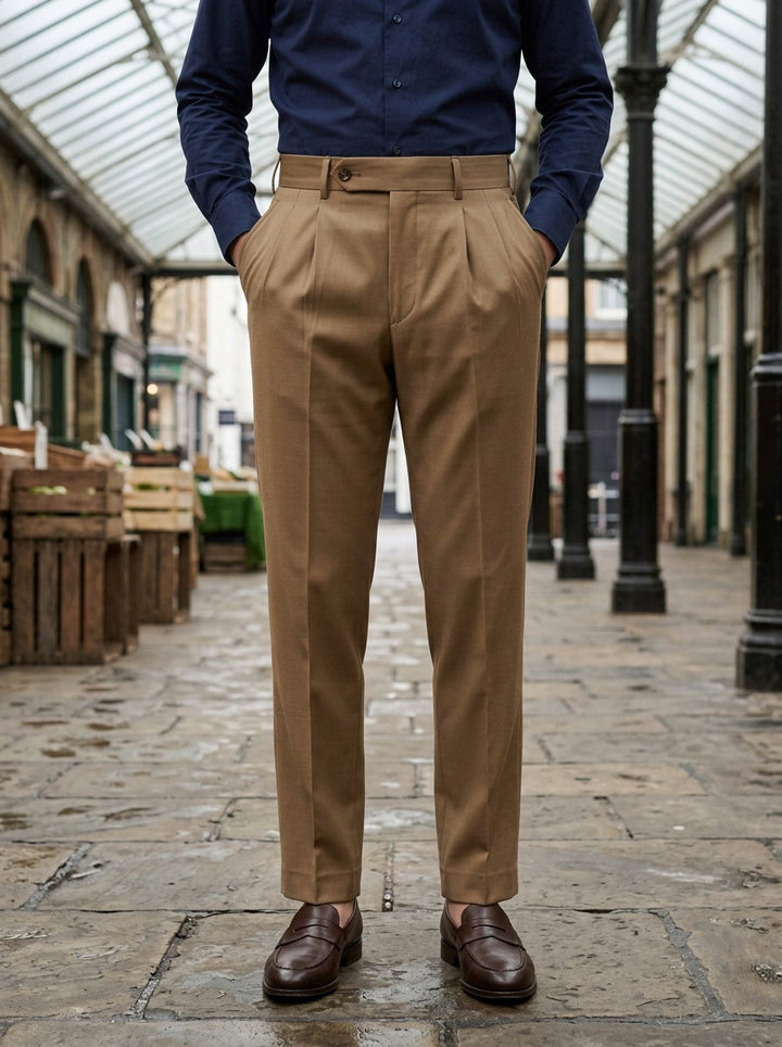 Prewitt button tab trousers in Camel, lifestyle in a covered market hall, Gentlemens Manor