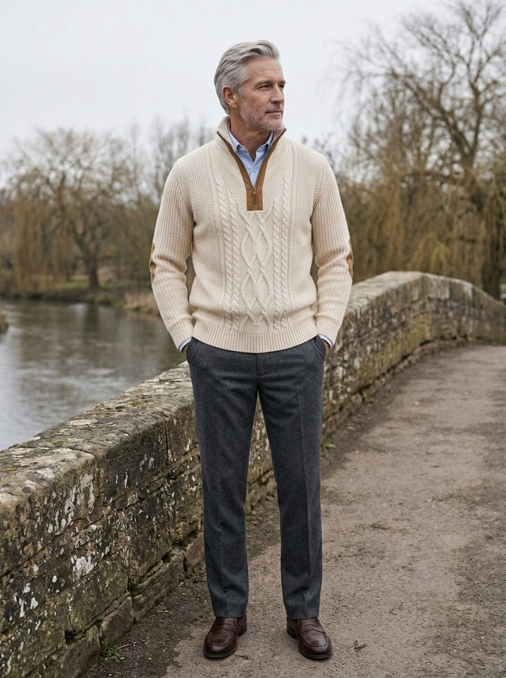 Pritchard cable knit quarter zip sweater in Cream, lifestyle on a stone footbridge, Gentlemens Manor