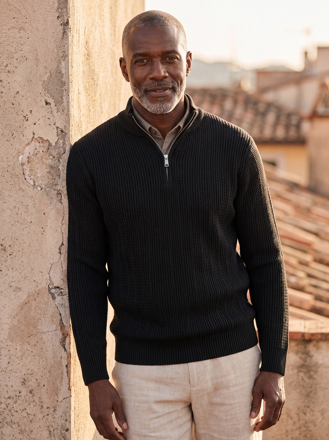 Prosper sweater in Black, worn by a model in a Mediterranean setting - Gentlemens Manor lifestyle