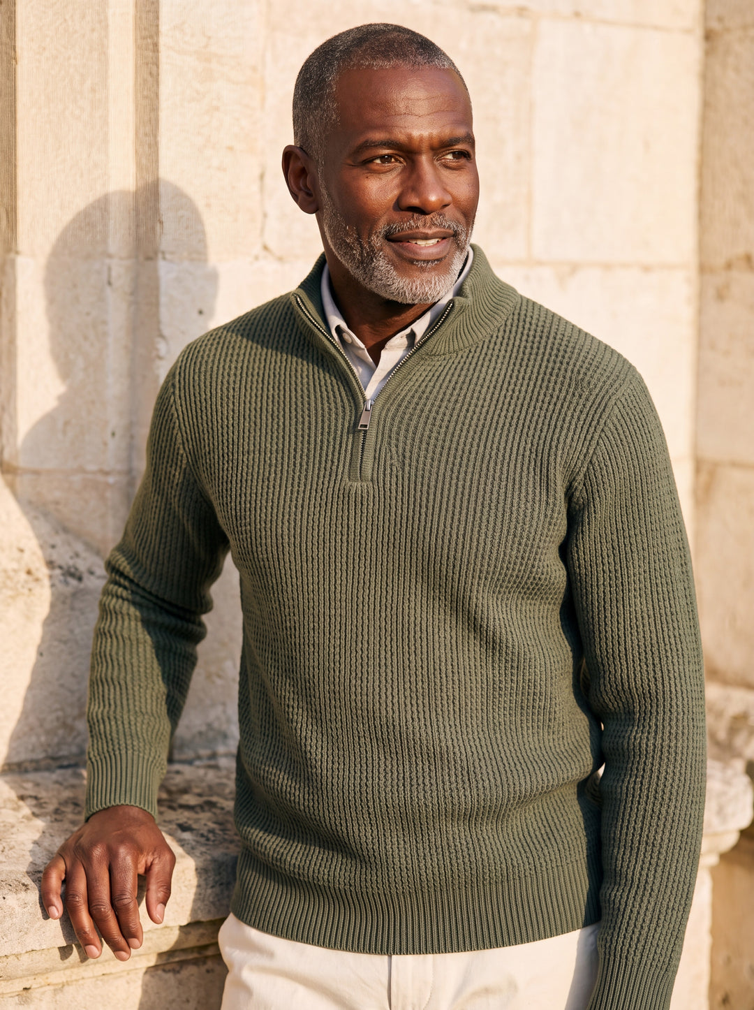 Prosper sweater in Green, worn by a model in a Mediterranean setting - Gentlemens Manor lifestyle