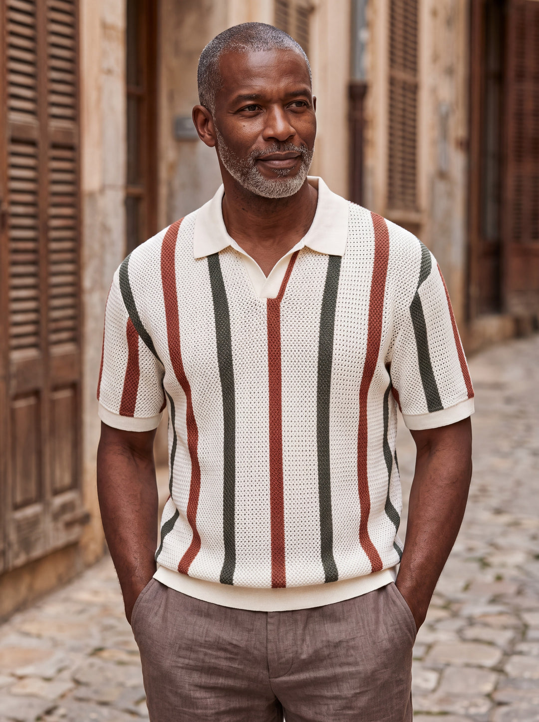 Quincy Men polo shirt in beige, worn by a model on a Mediterranean terrace - Gentlemens Manor lifestyle