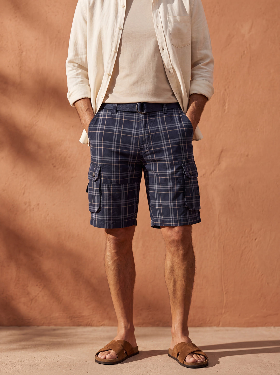 Quinton Men summer shorts in navy, worn by a model in a Mediterranean setting - Gentlemens Manor lifestyle