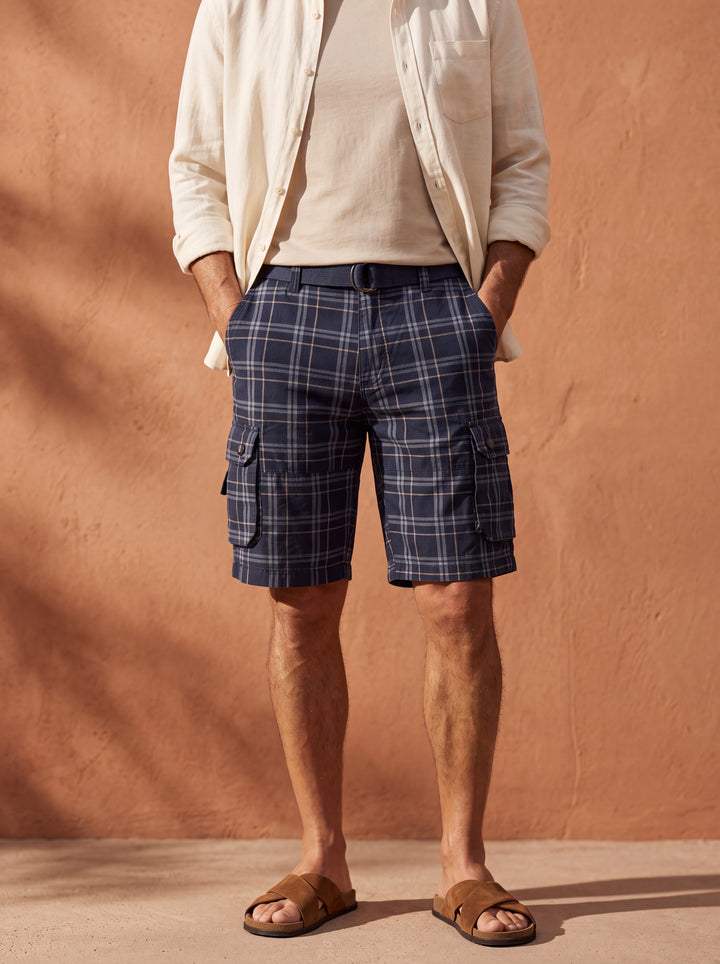 Quinton Men summer shorts in navy, worn by a model in a Mediterranean setting - Gentlemens Manor lifestyle