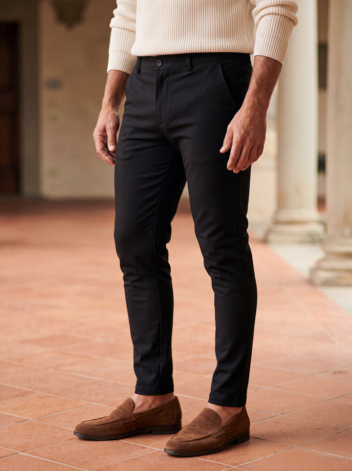Quinton trousers in Black, worn by a model in a Mediterranean setting - Gentlemens Manor lifestyle
