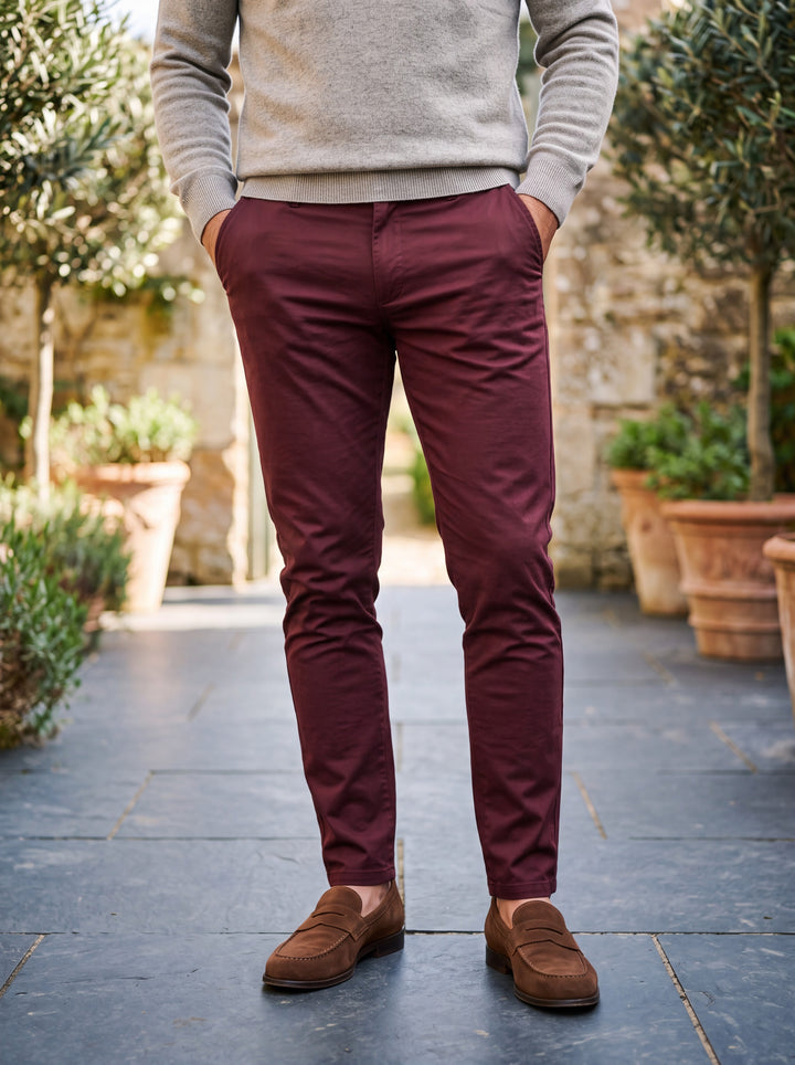 Quinton trousers in Burgundy, worn by a model in a Mediterranean setting - Gentlemens Manor lifestyle