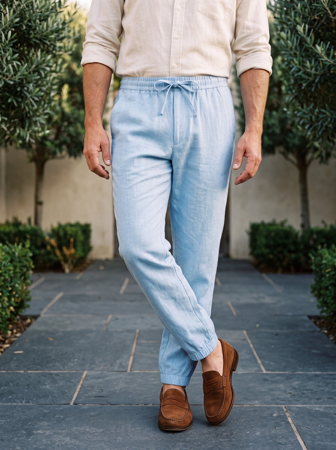 Raleigh trousers in Light Blue, worn by a model in a Mediterranean setting - Gentlemens Manor lifestyle