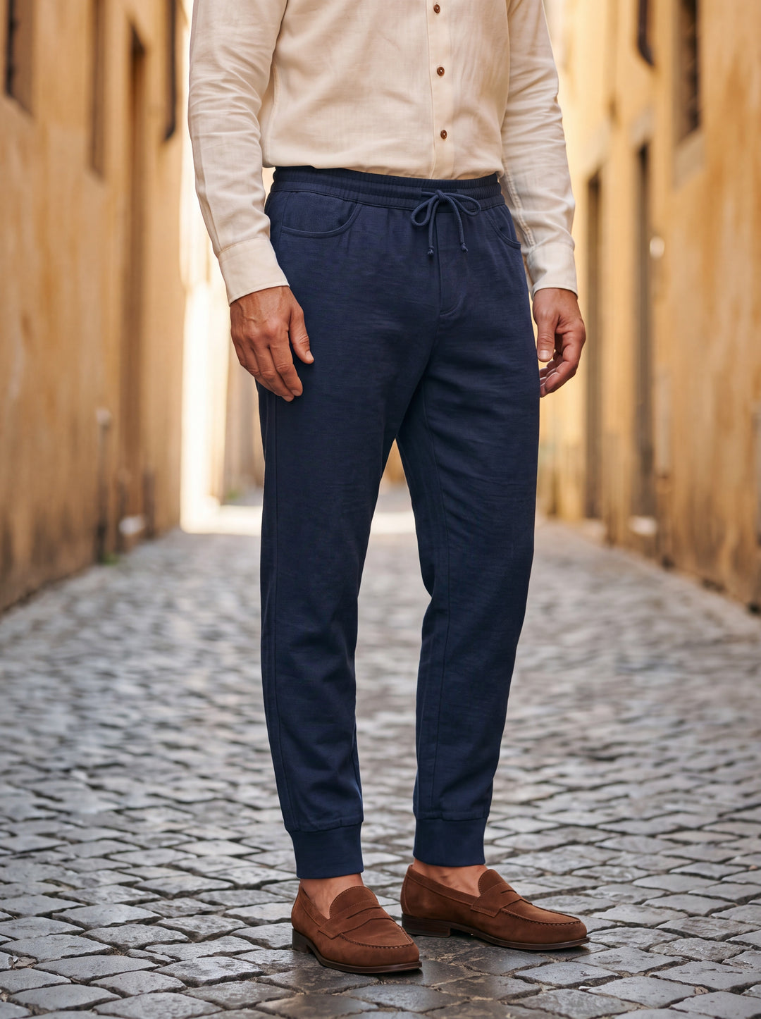 Raleigh trousers in Navy, worn by a model in a Mediterranean setting - Gentlemens Manor lifestyle
