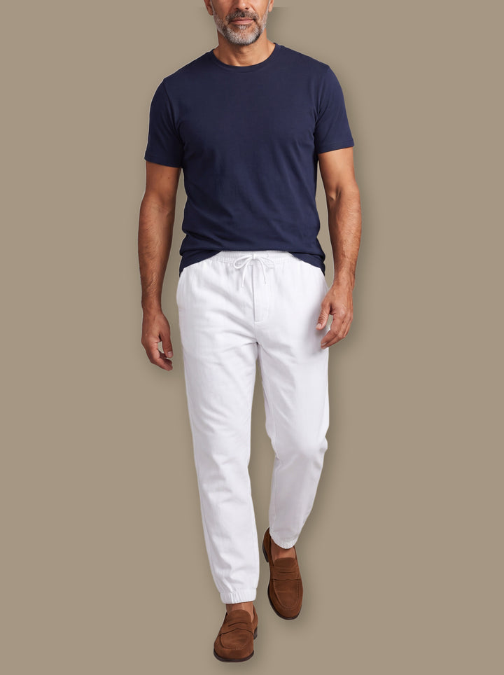 Raleigh trousers in White, worn by a model on a warm taupe studio background - Gentlemens Manor