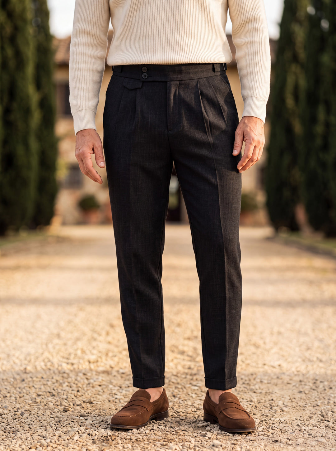 Ramsey trousers in Black, worn by a model in a Mediterranean setting - Gentlemens Manor lifestyle