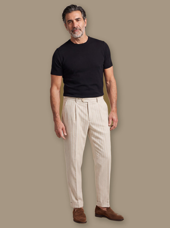 Randolph trousers in Cream, worn by a model on a warm taupe studio background - Gentlemens Manor