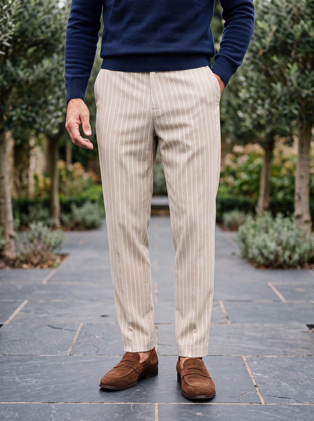 Randolph trousers in Cream, worn by a model in a Mediterranean setting - Gentlemens Manor lifestyle