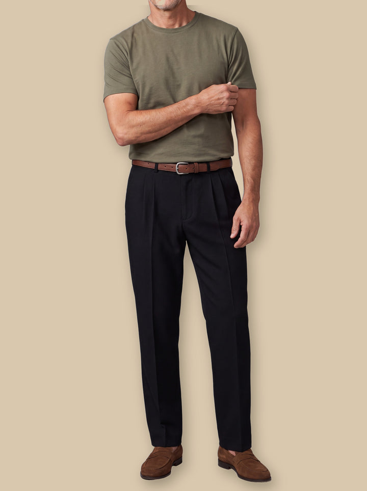 Raphael trousers in Black, worn by a model on a warm sand studio background - Gentlemens Manor