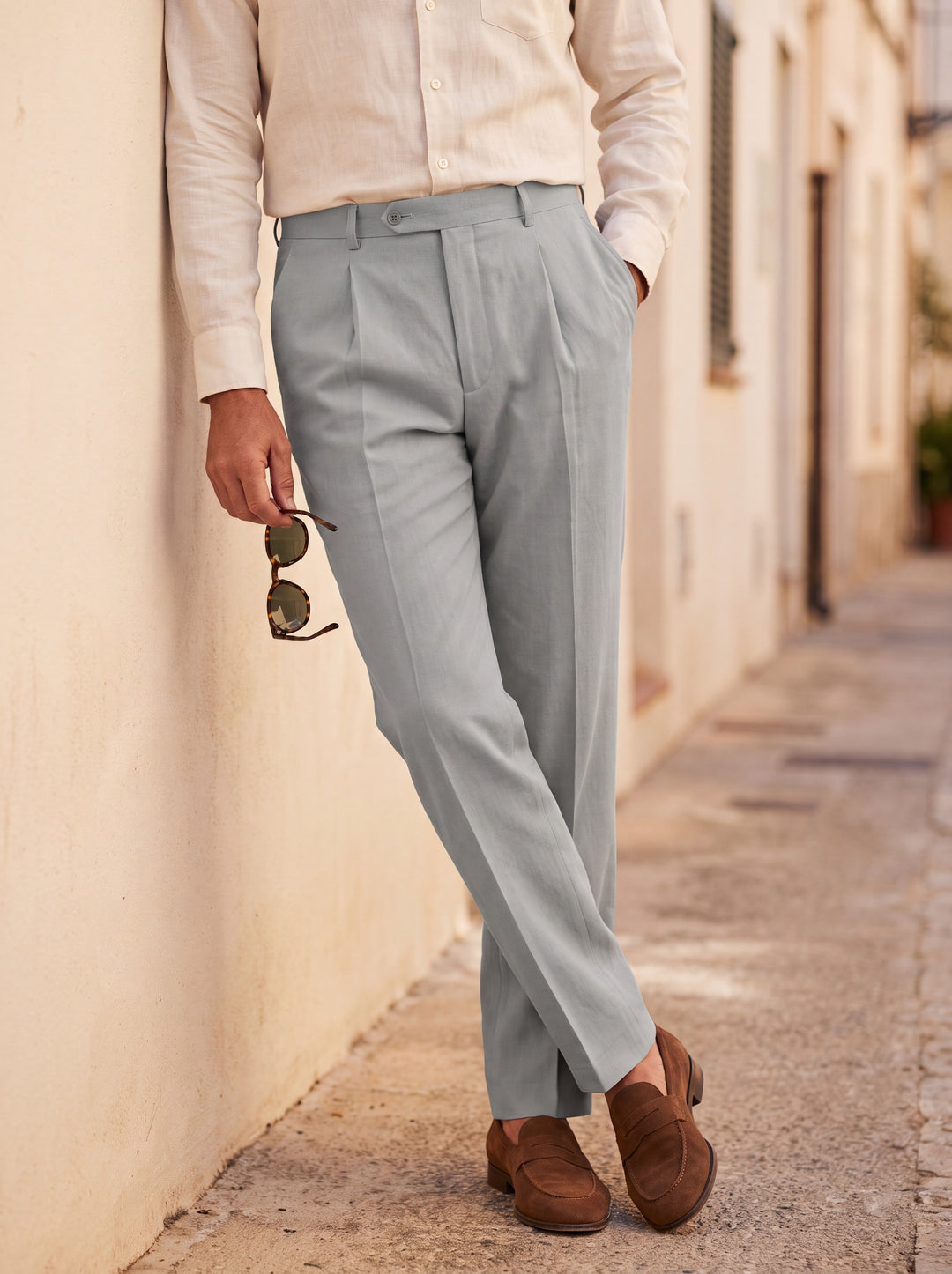 Raphael Men trousers in Grey, worn by a model on a Mediterranean terrace - Gentlemens Manor lifestyle