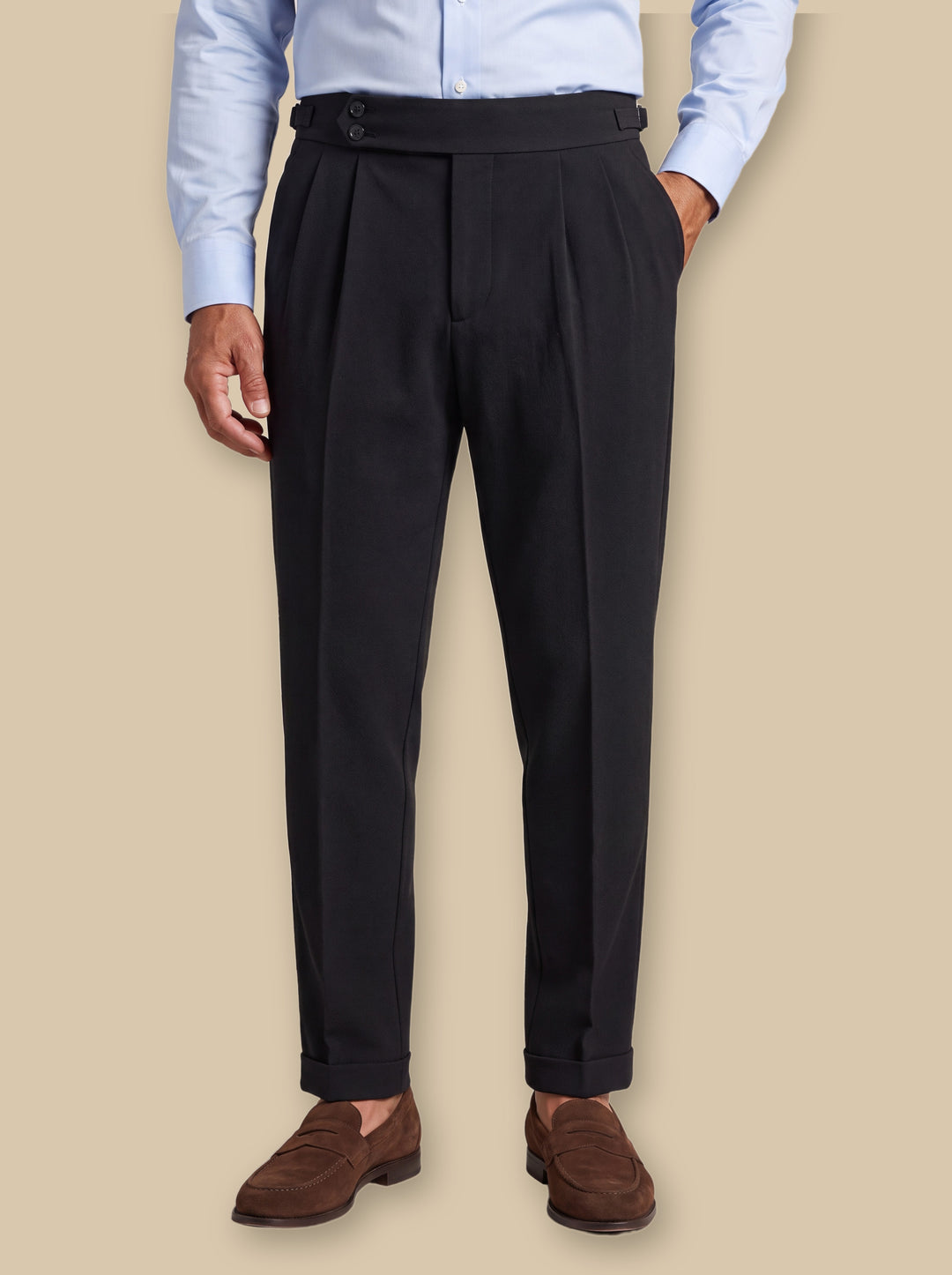 Raymond dress pants in Black, worn by a model on a warm sand studio background - Gentlemens Manor