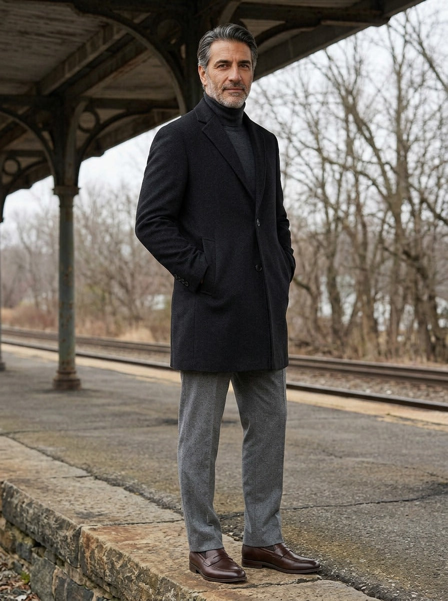 Redmond coat in Black, lifestyle on a railway platform, Gentlemens Manor