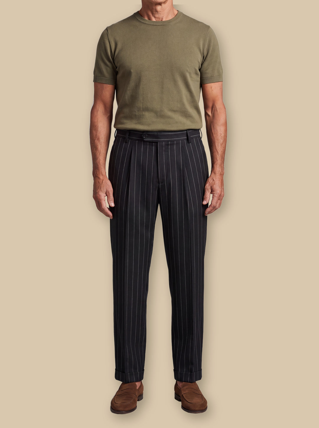 Reed trousers in Black, worn by a model on a warm sand studio background - Gentlemens Manor