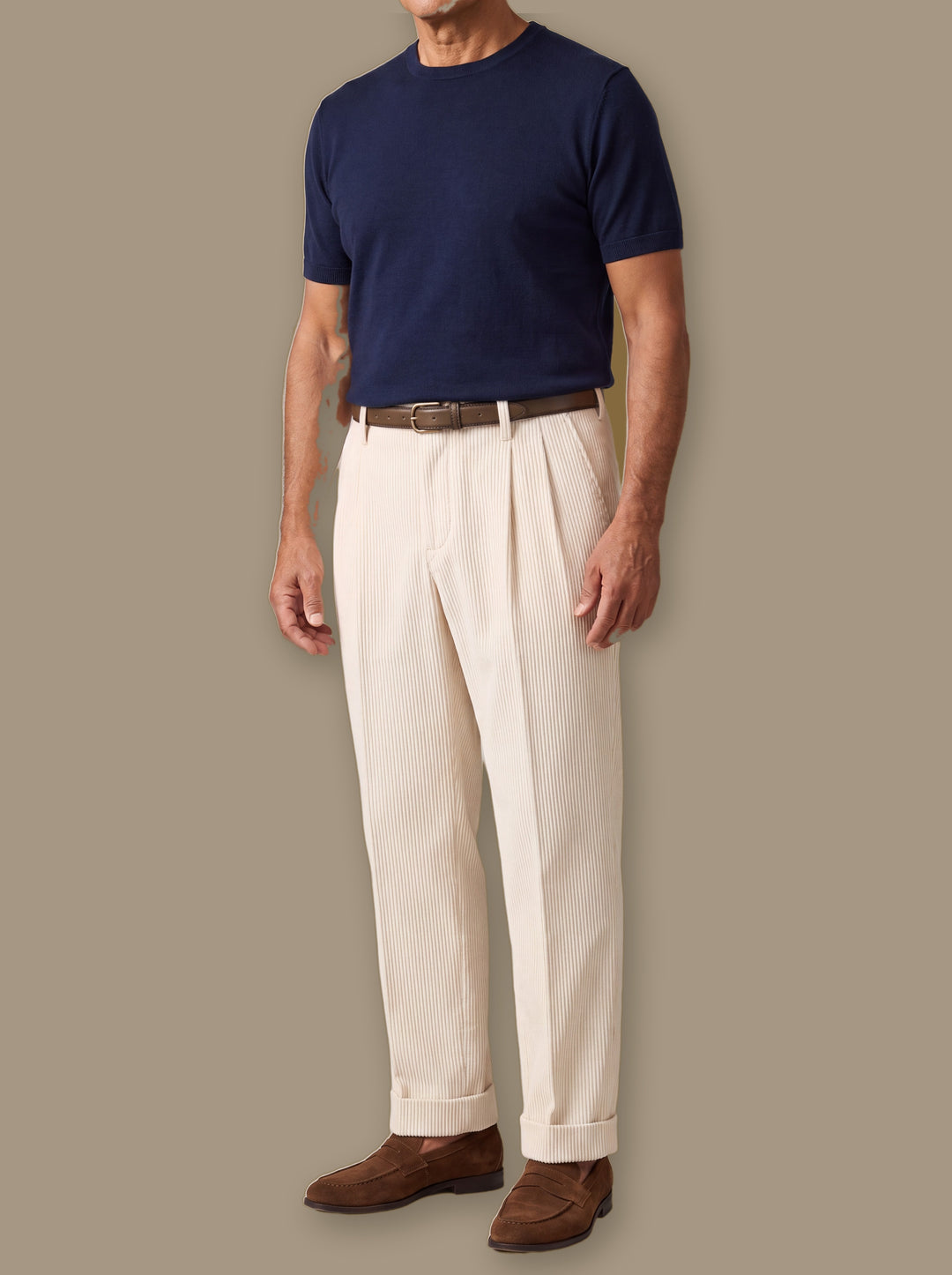 Reginald trousers in Beige, worn by a model on a warm taupe studio background - Gentlemens Manor