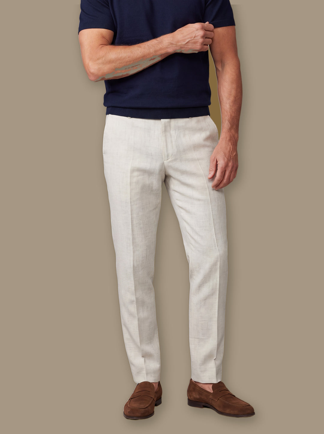 Remington trousers in Cream, worn by a model on a warm taupe studio background - Gentlemens Manor