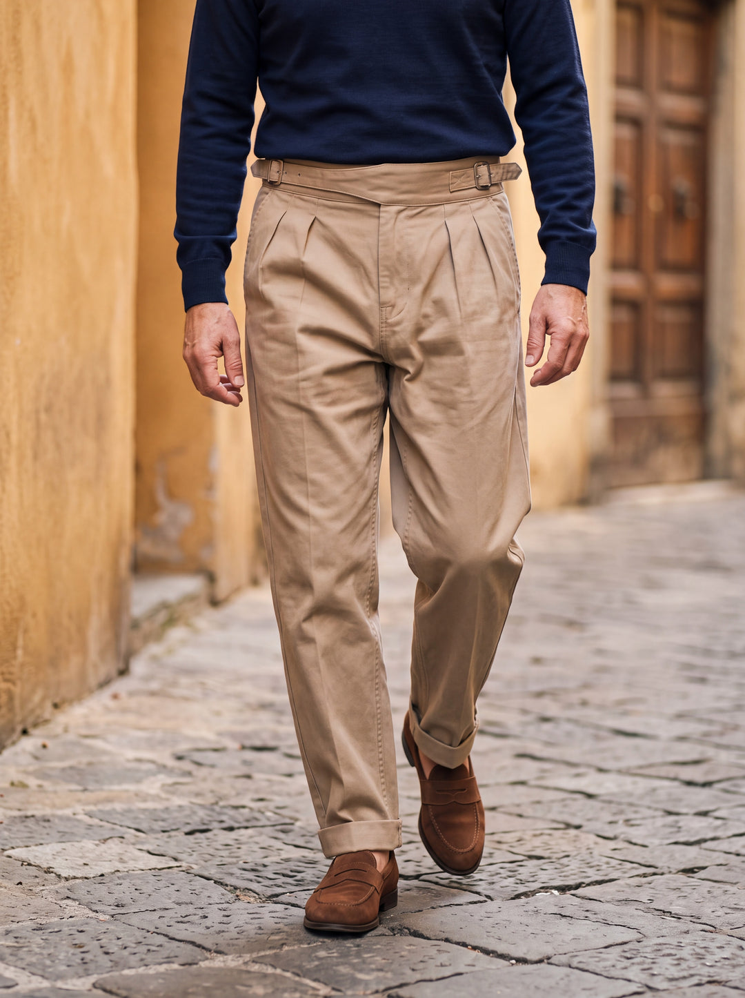 Reuben trousers in Sand, worn by a model in a Mediterranean setting - Gentlemens Manor lifestyle