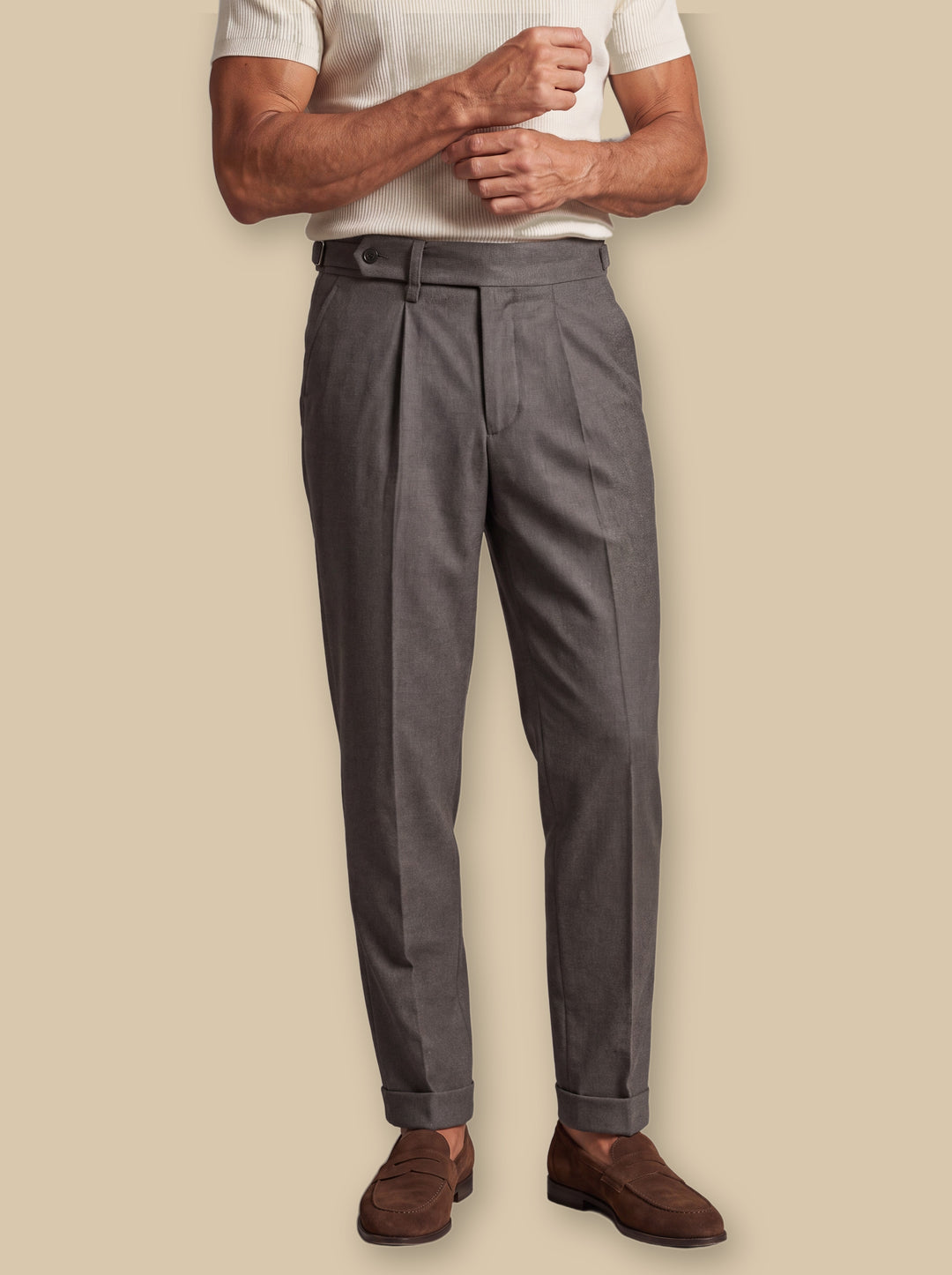 Ridley trousers in Grey, worn by a model on a warm sand studio background - Gentlemens Manor