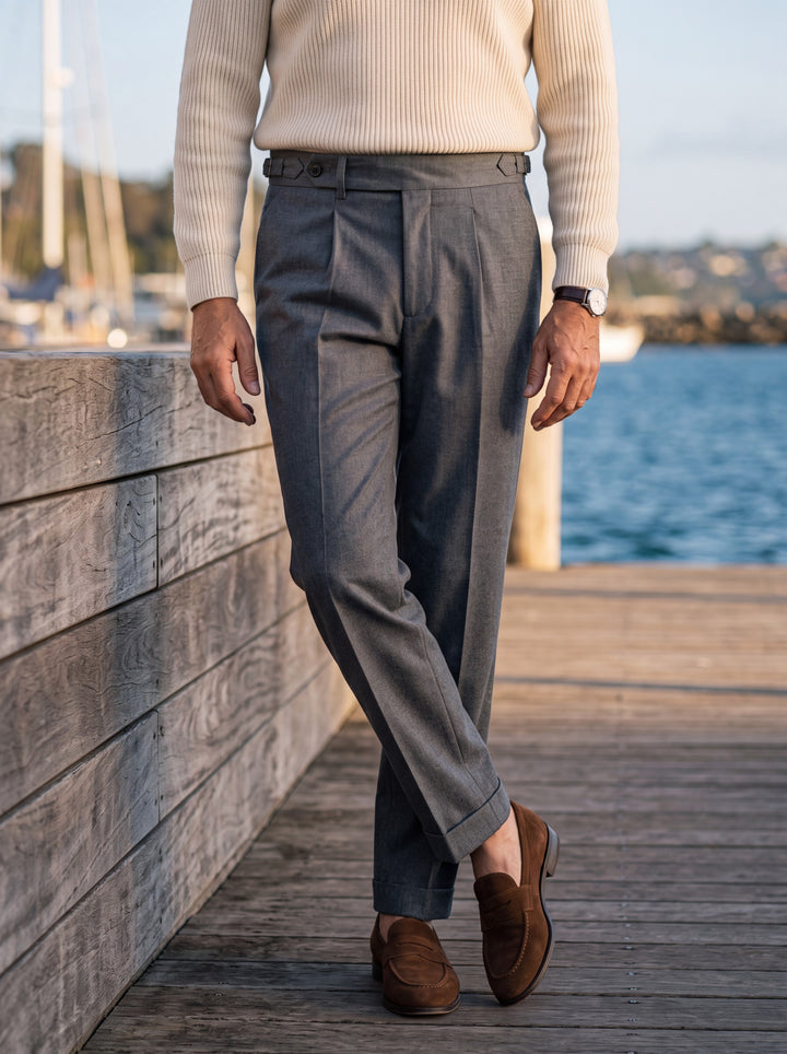Ridley trousers in Grey, worn by a model in a Mediterranean setting - Gentlemens Manor lifestyle