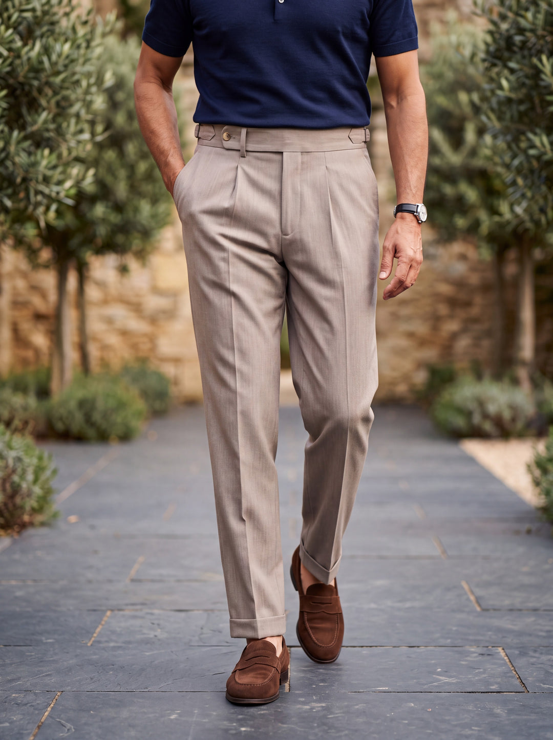 Ridley trousers in Sand, worn by a model in a Mediterranean setting - Gentlemens Manor lifestyle