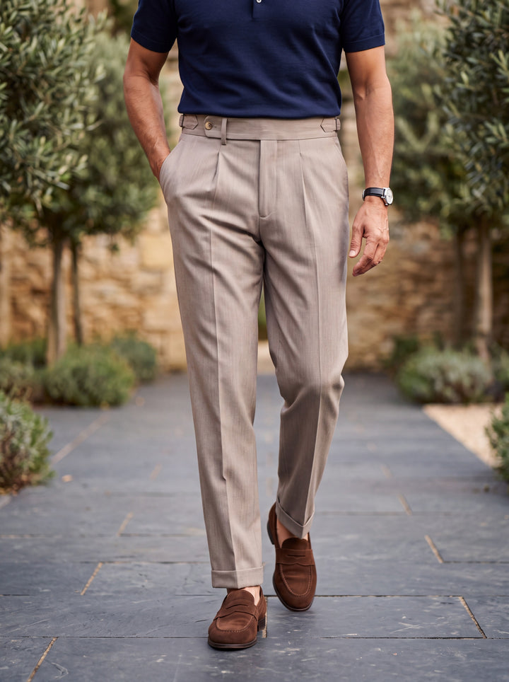 Ridley trousers in Sand, worn by a model in a Mediterranean setting - Gentlemens Manor lifestyle