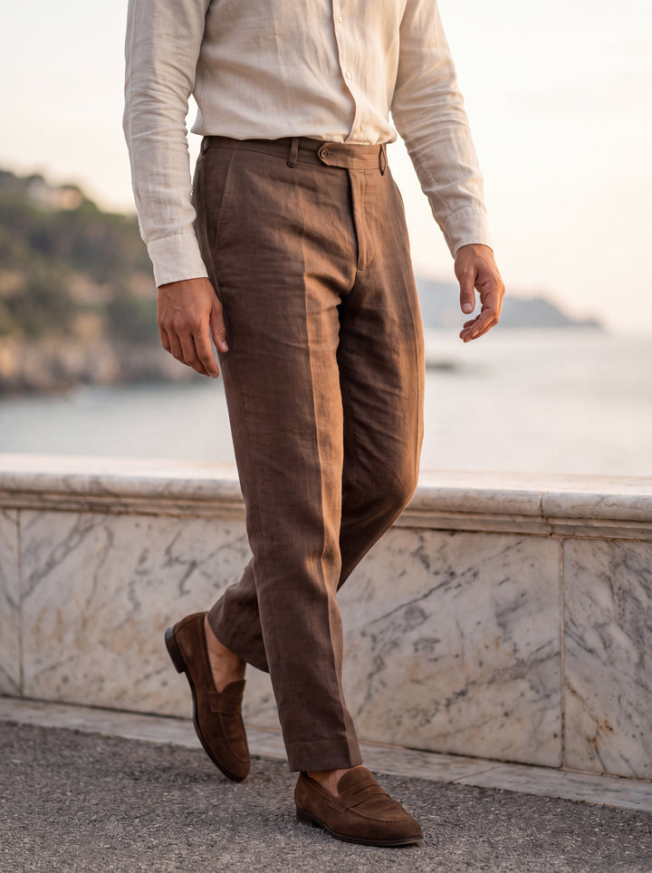 Robert Men trousers in brown, worn by a model on a Mediterranean terrace - Gentlemens Manor lifestyle