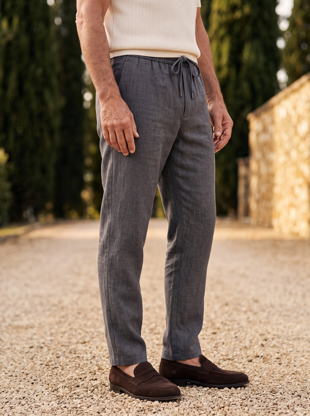 Roger trousers in Charcoal, worn by a model in a Mediterranean setting - Gentlemens Manor lifestyle