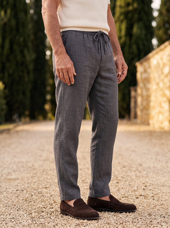 Roger trousers in Charcoal, worn by a model in a Mediterranean setting - Gentlemens Manor lifestyle