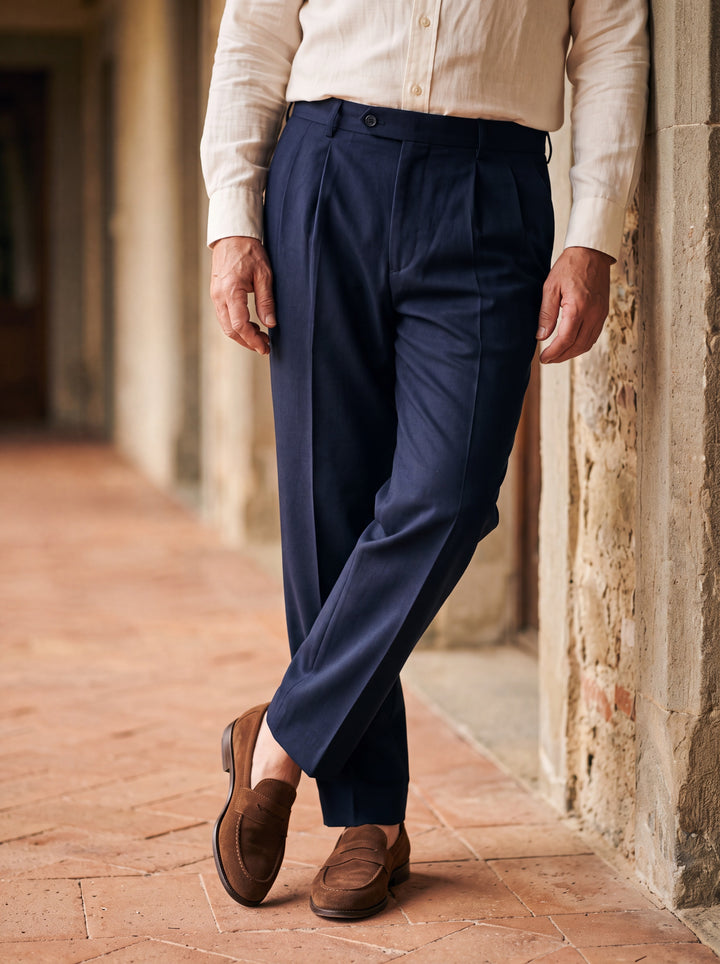 Roland trousers in Navy, worn by a model in a Mediterranean setting - Gentlemens Manor lifestyle