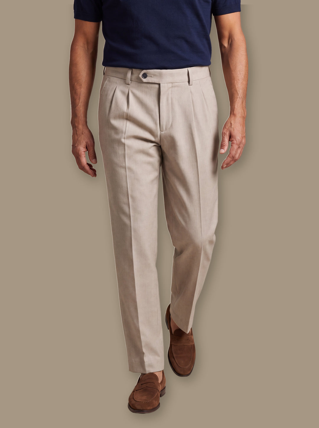Roman trousers in Beige, worn by a model on a warm taupe studio background - Gentlemens Manor