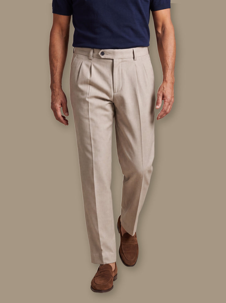 Roman trousers in Beige, worn by a model on a warm taupe studio background - Gentlemens Manor
